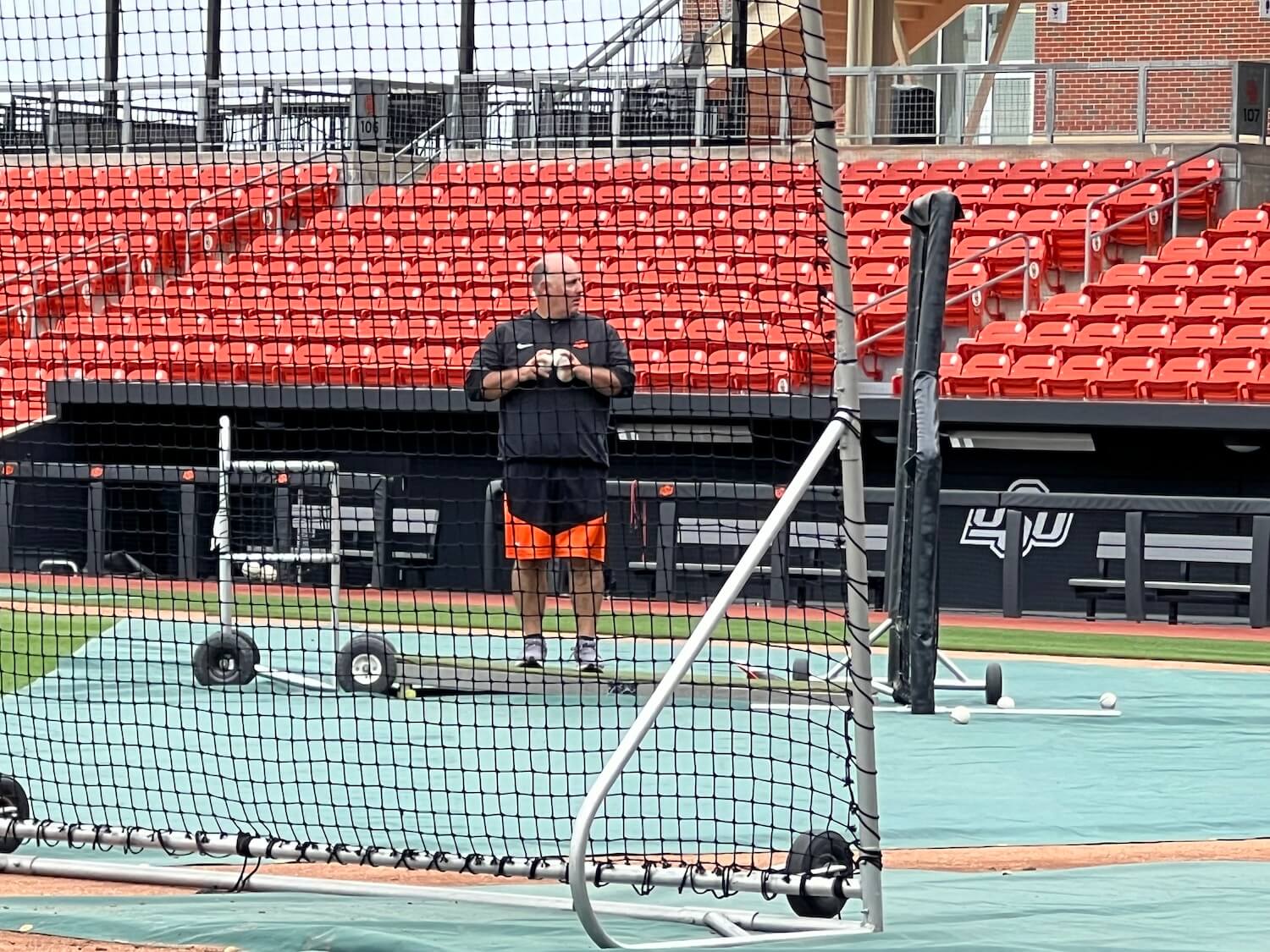 Coach Josh Holliday, brother of All Star Matt, uncle of first round picks Jackson and Ethan, throws bp because even though nearly 75 percent of players drafted in 2025 came out of NCAA programs they are allowed only four assistant coaches.