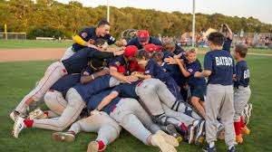 The victorious Bourne Braves pile-driving each other into Eldredge Park dirt. "And on our mound," said Miss Sue. Credit: Cape Cod League