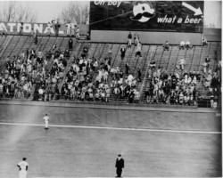 The ball kissed Mr. Boh’s cheek as it soared over the left field bleachers. Young boys peer over the wall searching for the ball.